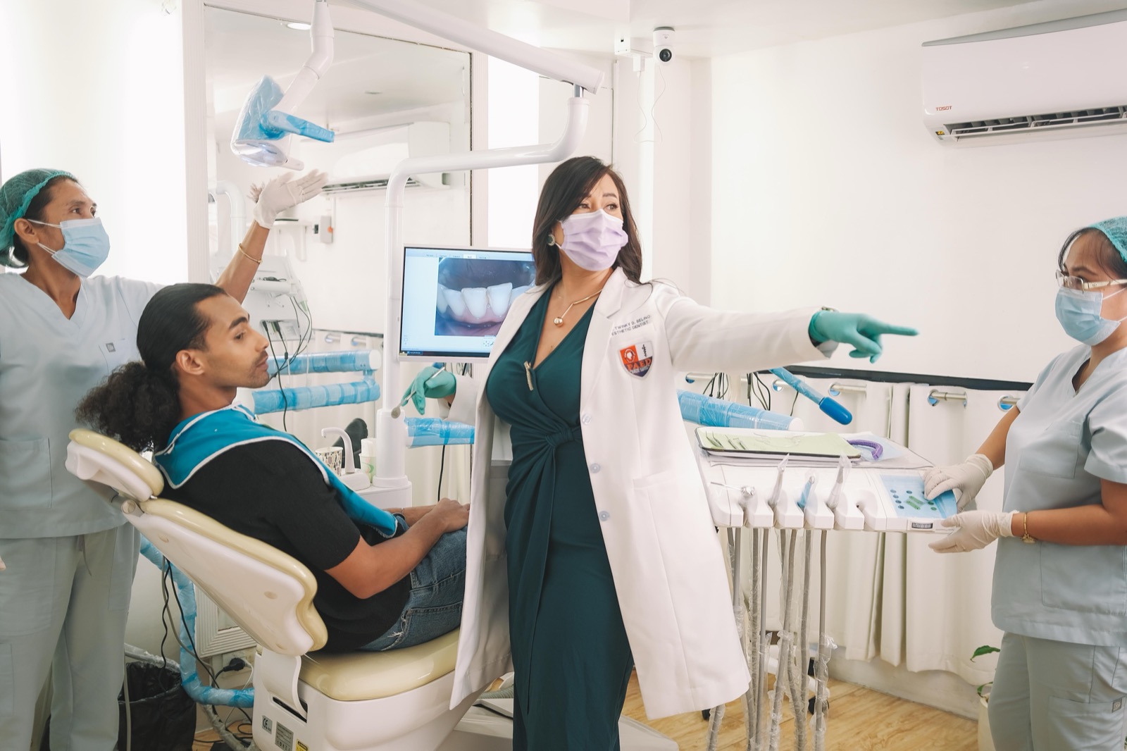 Dentist and clinical team placing a porcelain crown
